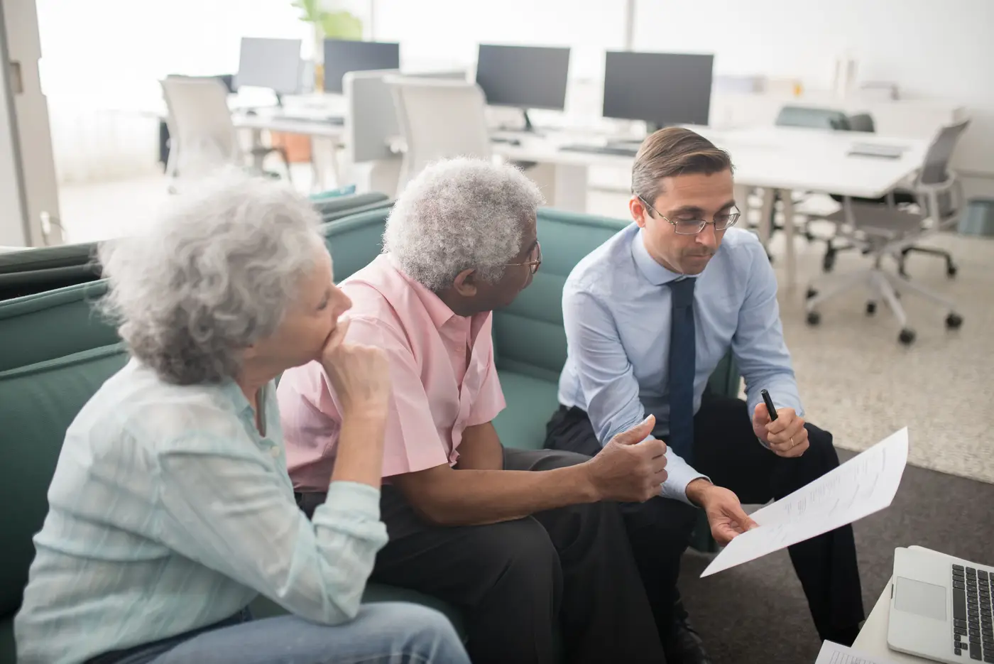 An attorney meeting with an older couple to review their documents
