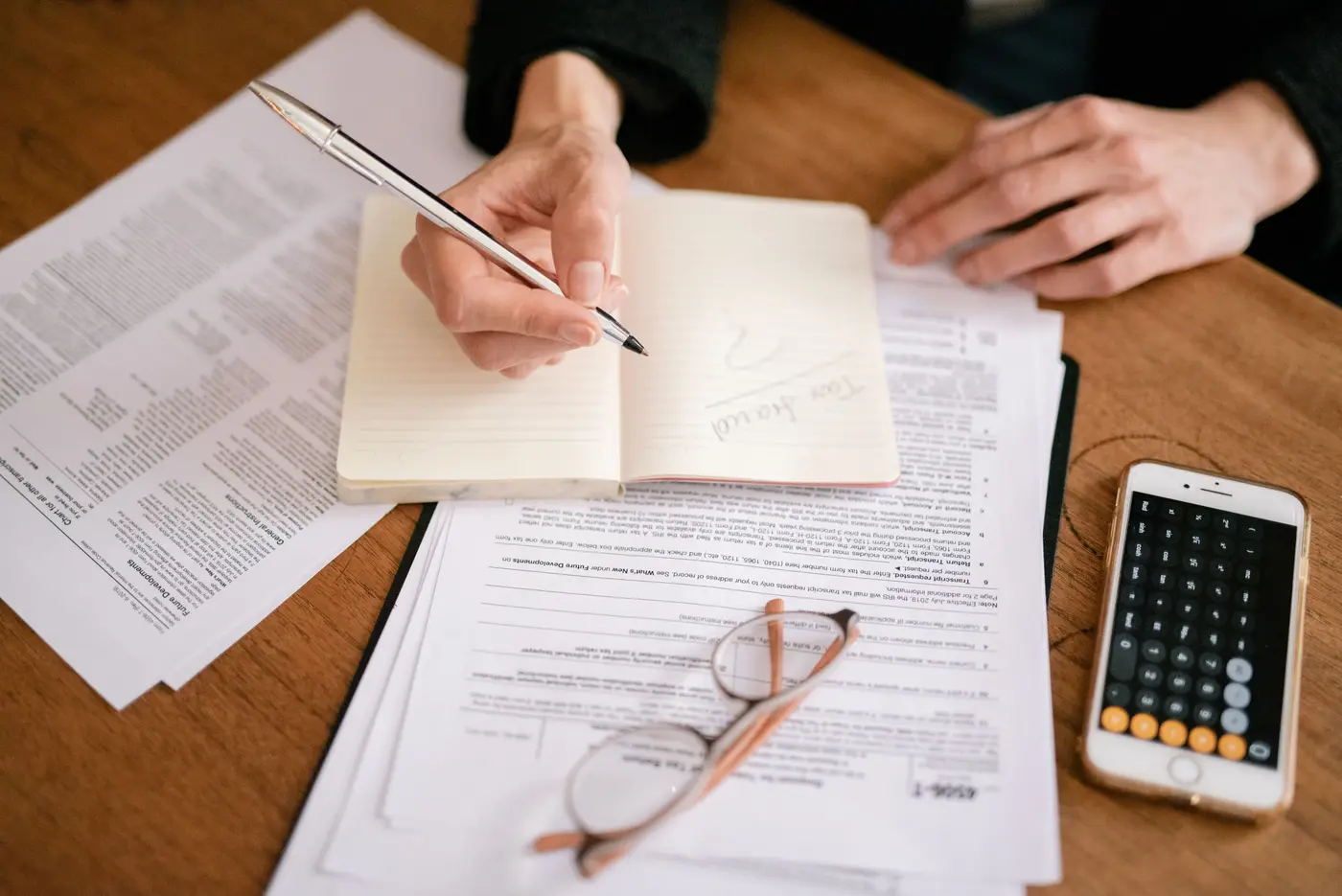 An executor keeping records of estate accounts with a notebook and statements